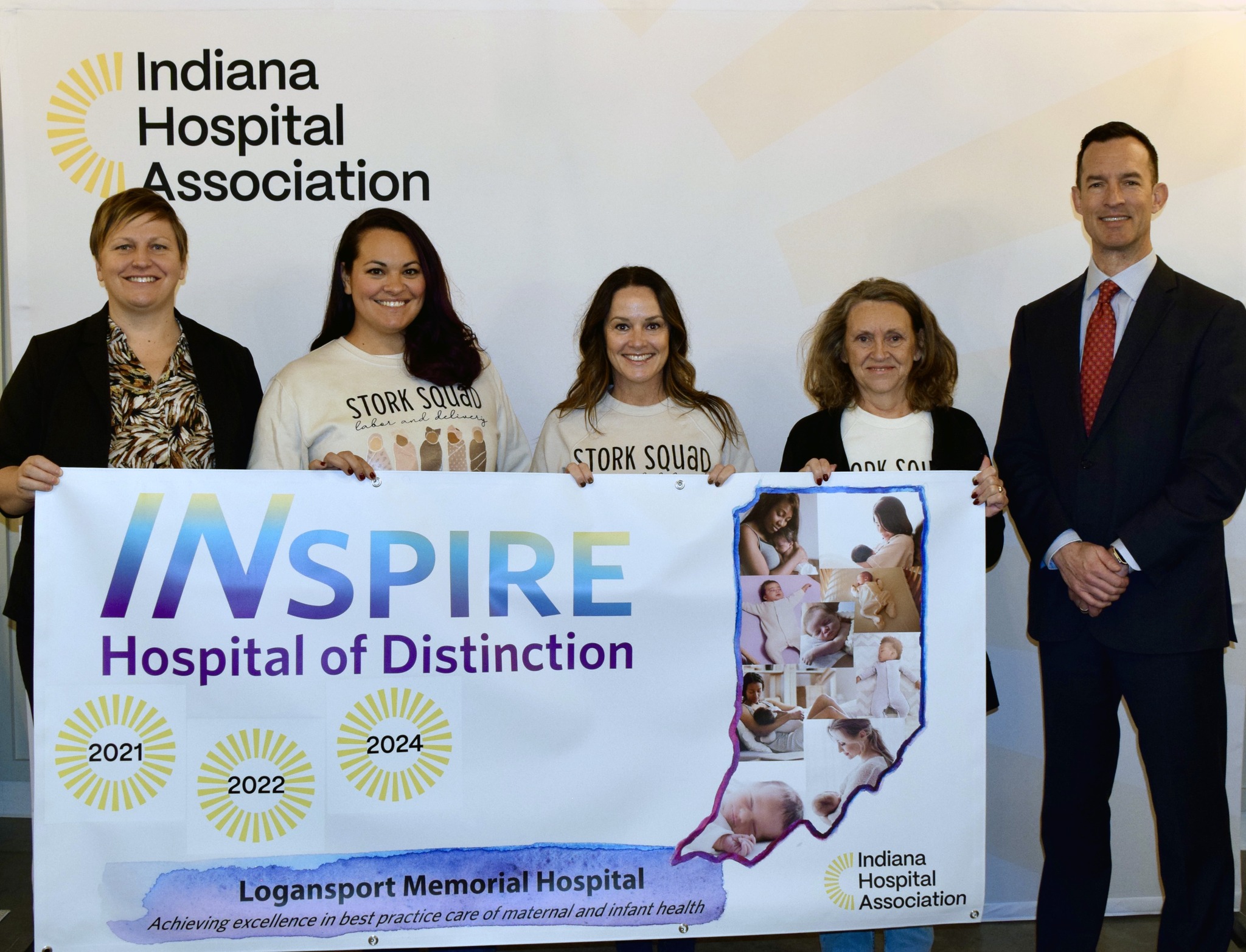 Logansport Memorial  Hospital and Indiana Hospital Association representatives with INSPIRE Hospital of Distinction banner.